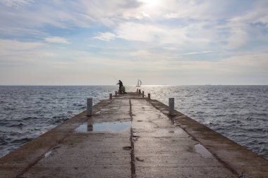 Balıkçı Şafakta deniz iskelede. Odesa şehri. Ukrayna