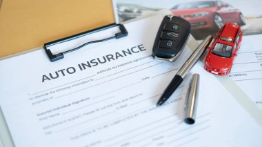 Vehicle insurance contract with pen car key and red toy car symbolizing driver safety accident claim responsibility financial stability and reliable legal coverage