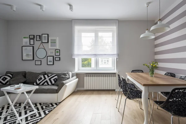 Modern apartment with gray sofa and wooden table