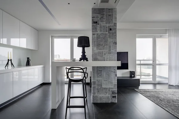 Modern black and white interior with magazine themed wallpaper