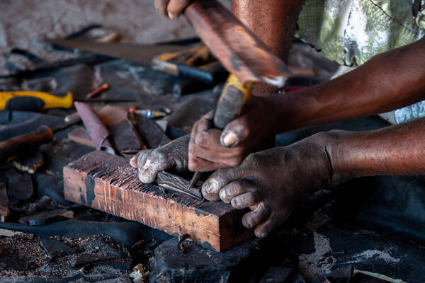 Close-up of a man making souvenirs from mangrove wood, Zanzibar