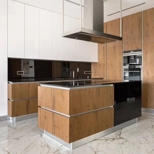 Modern and elegant kitchen with marble floor tiles, wooden and white furniture and kitchen island