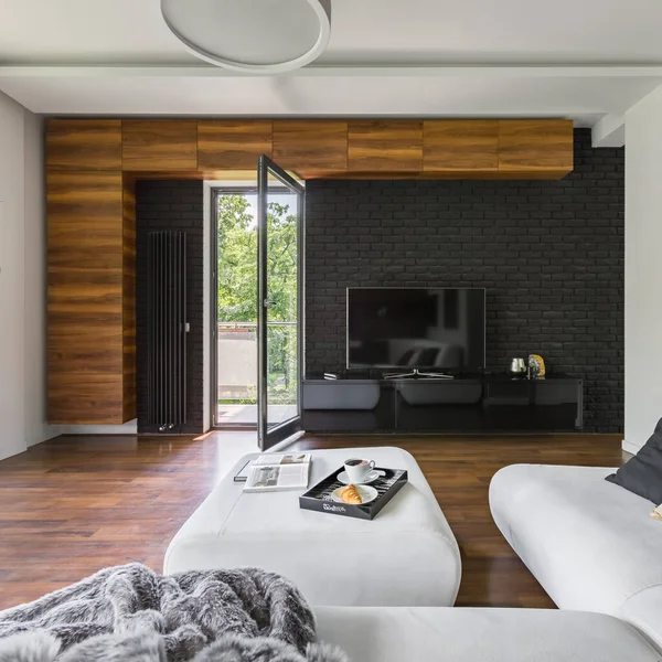 Elegant Living Room Black Brick Wall Television White Sofa Ottoman — Stock Photo, Image