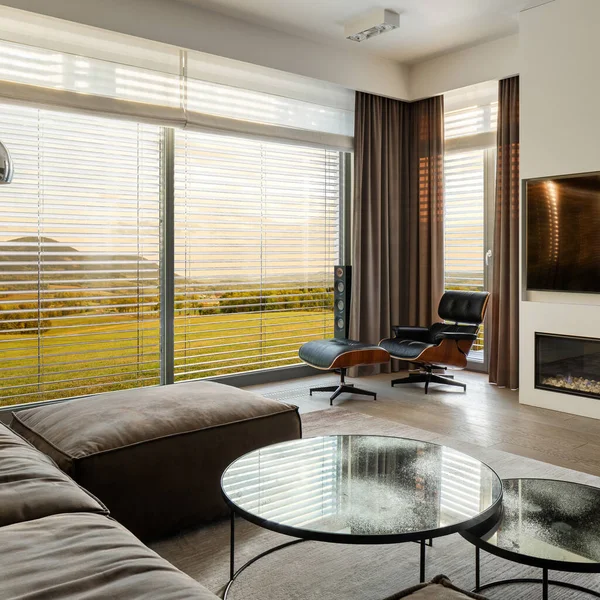 スタイリッシュな家具 モダンな暖炉 大きなテレビ画面と美しい景色を望む窓の壁と豪華な設計されたリビングルーム — ストック写真