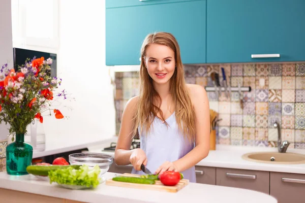 Hermosa chica haciendo ensalada en la cocina —  Fotos de Stock