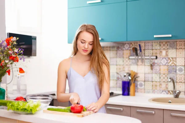 Hermosa chica haciendo ensalada en la cocina —  Fotos de Stock