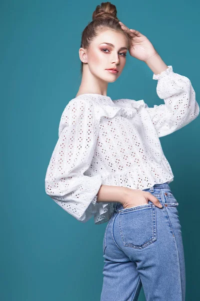 Teen girl posing in studio on blue background — Stock Photo, Image