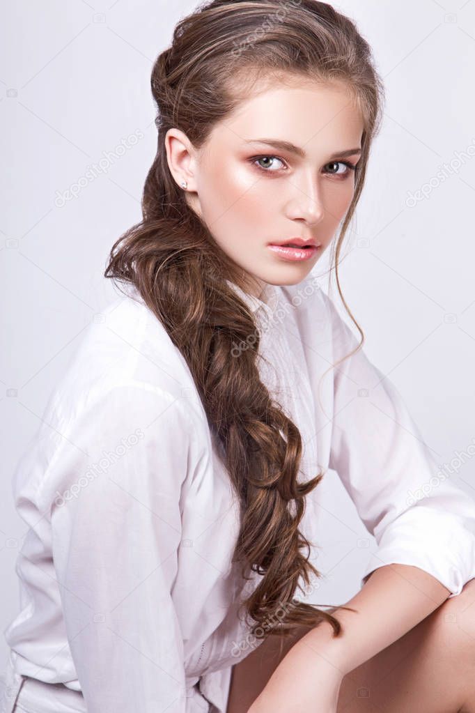 teen girl posing in studio on white background