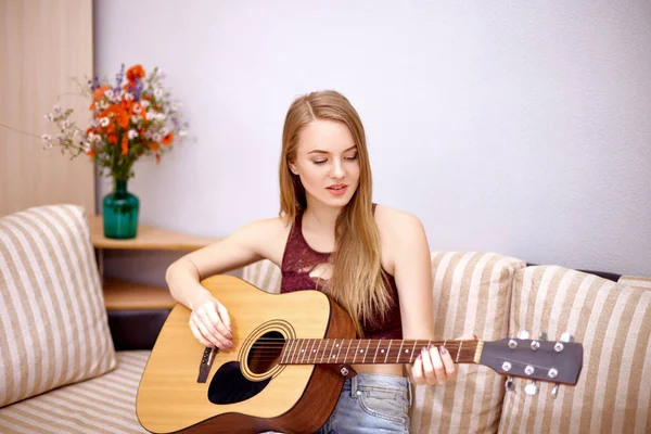 Beautiful blonde plays the guitar