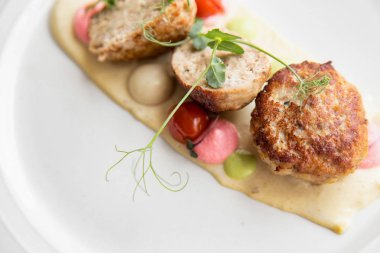 Beyaz bir tabakta soslu köfte