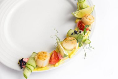 Fried scallop  on a white plate 