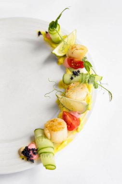 Fried scallop  on a white plate 