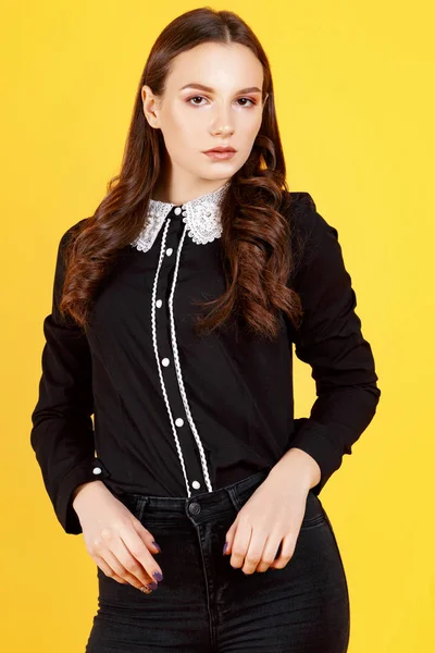 Girl in the studio on a yellow background — Stock Photo, Image