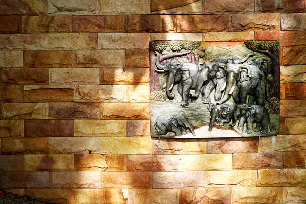 Elephant family art on sandstone on granite wall interior