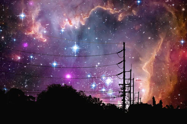 Galaxy floats in night sky above the shadow of an electric pole, Elements of this image furnished by NASA