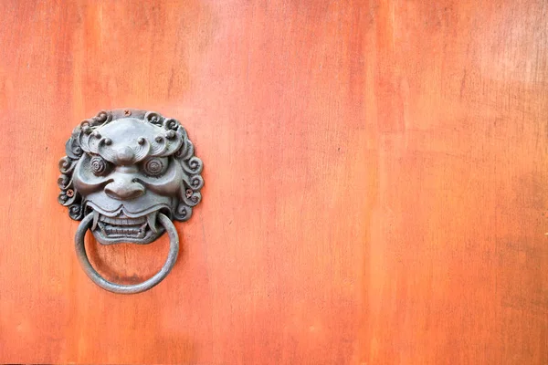 metal evil face pull door and hard wood surface background, concept : Don\'t open danger gate