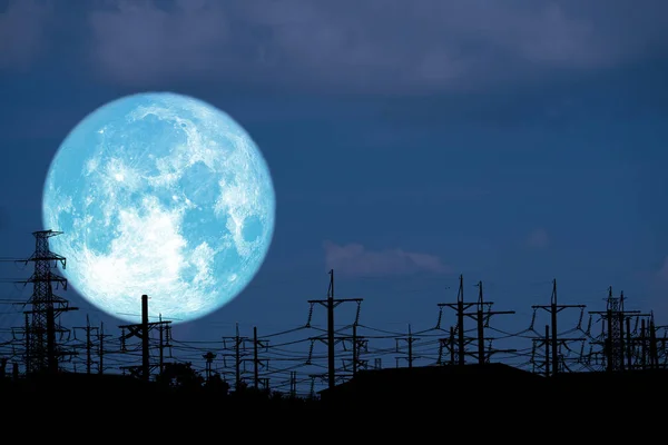 blue milk moon back on silhouette electric pole on night sky