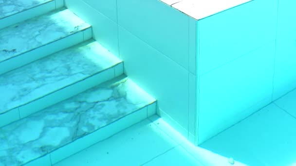 Marmeren trap van zwembad en muur getijden onder Aqua Color water — Stockvideo