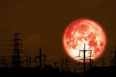 gece gökyüzünde siluet elektrik direğinde tam kırmızı süt ay geri
