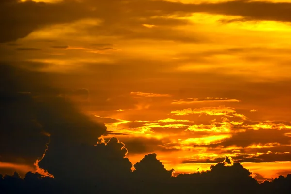 最後の明るい赤いオレンジ色の空のシルエット雲に戻って夕日 — ストック写真