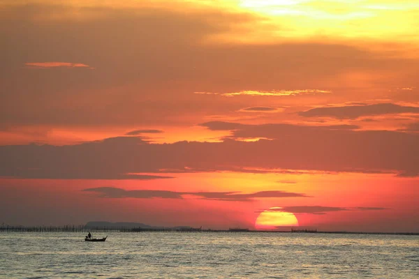 sunset on red yellow sky back evening cloud over horizon sea