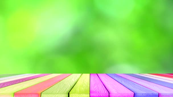 Green blur background abstract colorful leaves flower tree in garden and rainbow wood pieces floor — Stock Video