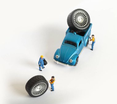 Atölye lastik uydurma kavramı. Tozlu oyuncak araba tekerleği, tamir minyatür mekaniği yakın çekim.