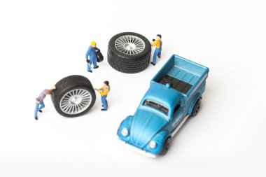 Atölye lastik uydurma kavramı. Tozlu oyuncak araba tekerleği, tamir minyatür mekaniği yakın çekim.