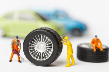 Atölye lastik uydurma kavramı. Tozlu oyuncak araba tekerleği, tamir minyatür mekaniği yakın çekim.