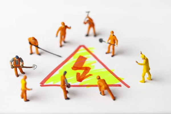 Miniature people on paper with lightning, electric power symbol. The concept of a collective solution to any problem.