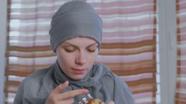Donna musulmana in un velo immerge il dito nel miele con le noci nel barattolo. Mangia il miele dal dito . — Video Stock