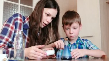 Kimya deneyleri evde. Anne ve oğlu gaz serbest ile kimyasal bir reaksiyon şişeye olun.