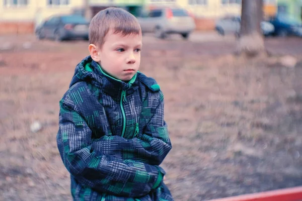 Triste chico sentado en un banco. Chico está perdido y esperando a los padres . — Foto de Stock