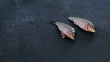 Adam temiz carps balık masanın üzerine koyar. Balık pişirme. Yakın çekim el.