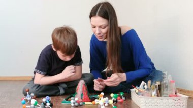 Anne ve oğlu gaz emisyon ile kimyasal reaksiyon bakarak. Evde hamuru yanardağ ile deneyimi.