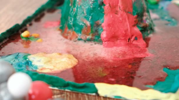 Closeup view of chemical reaction with gas emission. Experience with plasticine volcano at home. — Stock Video