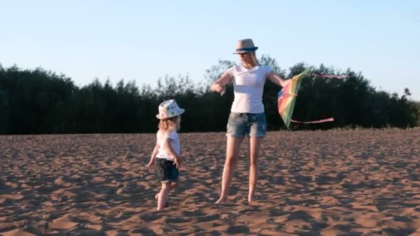 Hermosa Rubia Sombrero Mamá Hija Lanza Una Cometa Playa — Vídeos de Stock