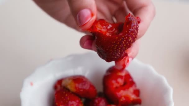 Woman kneads strawberry in her hand making jam. — Stock Video
