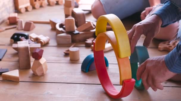 People build from wooden toys. Close-up hands. — Stock Video