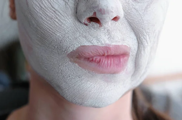 Clay mask on a womans face. Fitness for the face.