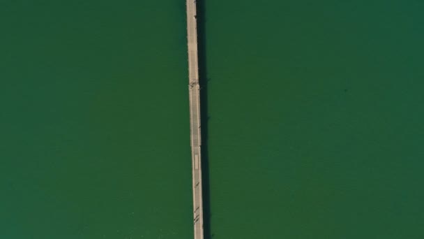 Black sea pier from the height. Aerial view photography over the sea. — Stock Video