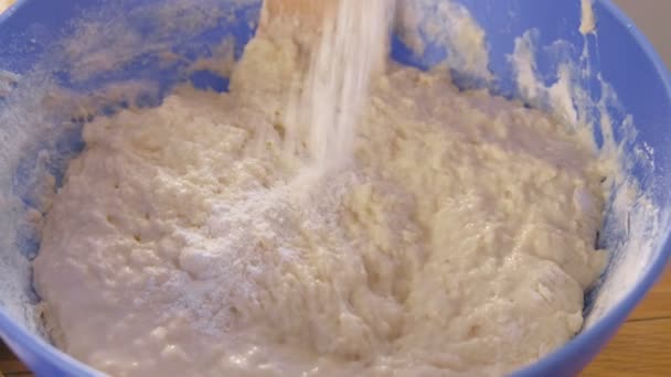 Preparation of yeast dough in a blue plastic bowl. Close-up view. — Stock Video