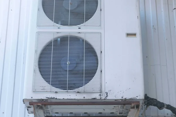 Old air conditioning on the street side. Fans are behind bars. Close-up view. — Stock Photo, Image