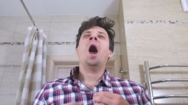 Ayna ve yawns onun yansıması sadece uyandı yorgun adam bakar.
