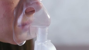 Nebulizatör ve astım tedavisi için kullanın. Genç kadın inhaler maskesi teneffüs edilmesi