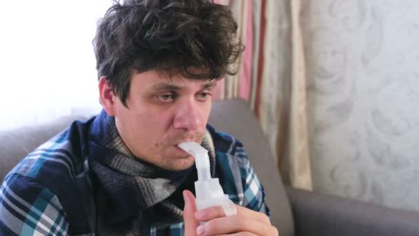 Vernebler und Inhalator für die Behandlung verwenden. Kranker Mann inhaliert durch Inhalationsdüse für Rachen. Gesicht aus nächster Nähe. — Stockvideo