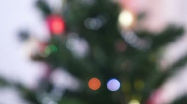 Kırmızı parlak topları ve altın oyuncaklar Noel ağacı dalları üzerinde. Noel ağacı ışıkları ile Noel çelenk. Bulanıklık.