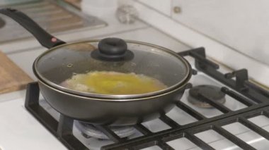 Sosisli gaz sobası üzerinde bir tavada omlet hazırlama.