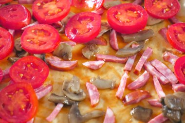 Pizza yapma. Ev yapımı pizza. Domates sosis ve mantar bir pizzaya koymak. Yakın çekim görünümü.