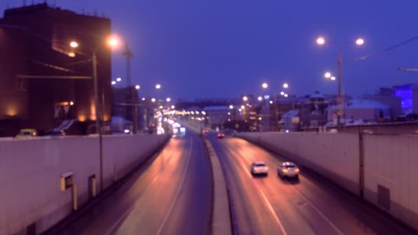 Six-lane road in the city at night, view from the bridge. — Stock Video